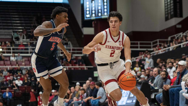 Dec 31, 2023; Stanford, California, USA; Stanford Cardinal guard Andrej Stojakovic (2) attempts to drive around Arizona Wildcats guard KJ Lewis (5) during the first half at Maples Pavilion. Mandatory Credit: Stan Szeto-USA TODAY Spor